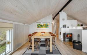 a kitchen and dining room with a table and chairs at Holiday Home Mosebøllevej Thisted Denm in Nørre Vorupør