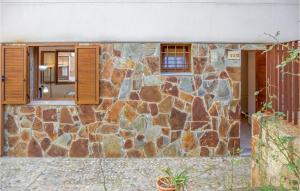 a stone house with a window and a stone wall at Cozy Apartment In Tossa De Mar, Girona in Tossa de Mar