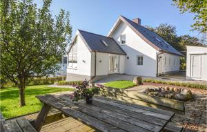 a house with a wooden bench in front of it at Three-Bedroom Holiday Home In Kolding in Kolding +22 photos