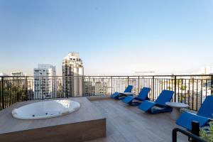 a group of blue chairs sitting on top of a building at My One Bela Vista - Studios por temporada in Sao Paulo
