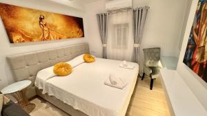 a room with a bed and a table with yellow bows at Apostolis House in Mýkonos City +45 photos