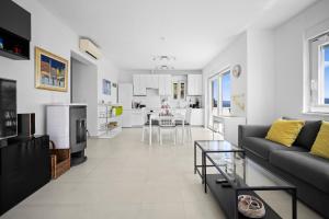 a living room with a couch and a table at House , Seafront Apartment Pelegrin in Stomorska