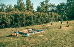 a park with a swing set in a field at Cozy Home In Södra Vi With Sauna in Södra Vi