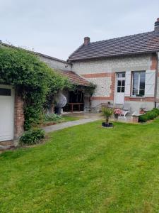 a house with a green yard in front of it at GITE, MAISON A LA CAMPAGNE ARDENNES, AISNE,MARNE in Le Thour