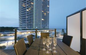 a wooden table with wine glasses on a balcony at Highend Travemünde - Whg 307 in Travemünde