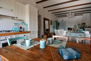 a kitchen with a wooden table in a kitchen with a tableablish at La Raganetta in Cartabubbo