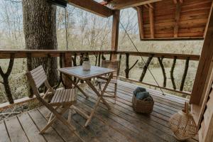 a table and chairs on a porch of a cabin at Ekia Basoa Suites in Lizaso