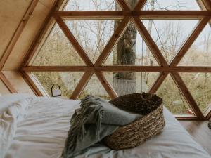 a bed in a room with a large window at Ekia Basoa Suites in Lizaso