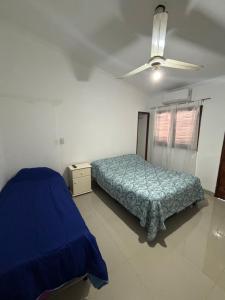 a bedroom with a blue bed and a window at Antu Sol in Salta