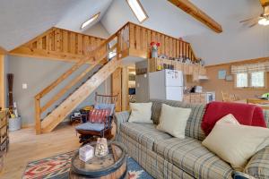 a living room with a couch and a staircase at Walk to Beach Pocono Lake Cabin with Pool Access! in Pocono Lake