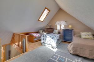 a attic room with a bed and a chair at Walk to Beach Pocono Lake Cabin with Pool Access! in Pocono Lake +18 photos