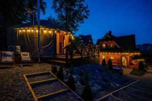 a yurt at night with lights on it at Jurta na Wypasie - luksusowy namiot z widokiem na góry - Jacuzzi, Sauna, Split AC, Private, Star View in Zakopane