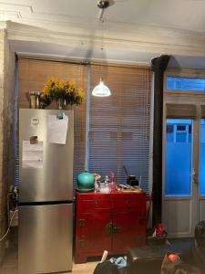 a kitchen with a refrigerator and a red cabinet at Large Parisian Duplex in Paris