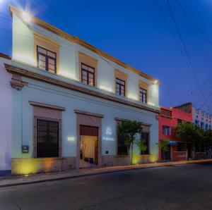 a white building on the side of a street at Palpatio Hotel Boutique in Guadalajara