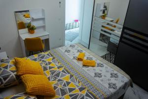 a bedroom with a bed with yellow pillows at Una deluxe home ELLA in Bihać +44 photos