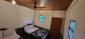 a small room with a couch and a window at SPM Residency, From Live2Travel Group. in Masinagudi