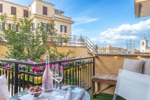 a balcony with a table and a bottle of wine at San Pietro Panoramic View in Rome