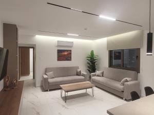 a living room with two couches and a coffee table at IOLENA Seaview Apartment in Pyla