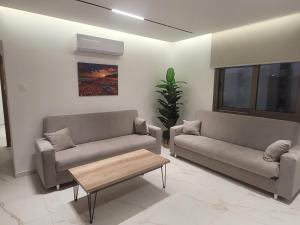 a living room with two couches and a coffee table at IOLENA Seaview Apartment in Pyla