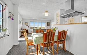 a kitchen and dining room with a table and chairs at Holiday Home Helnæsvej Haarby Ix in Brunshuse