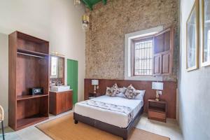a bedroom with a bed and a sink in it at Hotel Boutique Santa Elena in Mérida