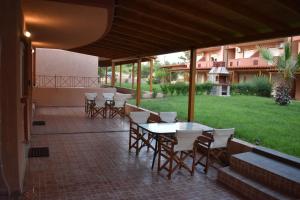 a patio with a table and chairs and a building at IKIES LUXURY MAISONETTE HALKIDIKI Psakoudia in Psakoudia