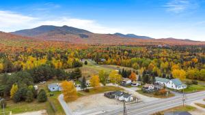 an aerial view of a home with fall foliage at Mount Washington by Day Hot tub by night #2 in Carroll