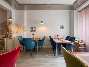 a dining room with two tables and blue chairs at Weserstern in Bremen