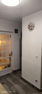 a white room with a clock on the wall at Jolie studio in Argenteuil
