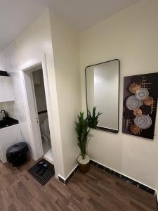 a room with a mirror and a potted plant at Studio with smart entry in Riyadh +2 photos