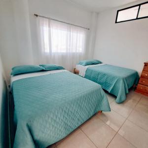 Postel nebo postele na pokoji v ubytování Hosteria La Veleta, Playas