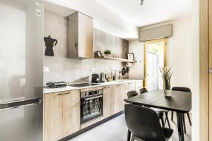 a kitchen with a table and a dining room at GRADO HOUSE-Garden & Hydromassage-Sea-Free Parking in Grado