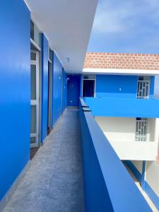 an empty corridor of a building with blue walls at Hotel MIRALMAR in El Puente