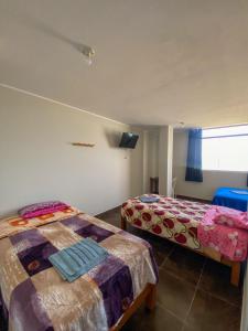 a bedroom with two beds and a flat screen tv at Hotel MIRALMAR in El Puente