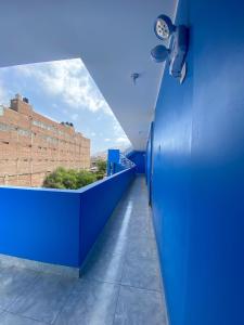 a hallway with blue walls and a blue wall at Hotel MIRALMAR in El Puente