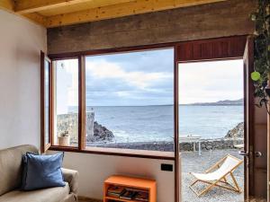 a living room with a view of the ocean at CA'MALÚ Estudio en el mar in Arrieta