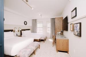 a hotel room with two beds and a desk at Hotel Heron Alexandria Old Town, Curio Collection by Hilton in Alexandria +194 photos