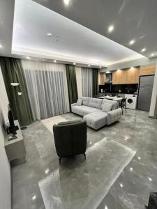 a large living room with a couch and a kitchen at Silence garden in Alanya
