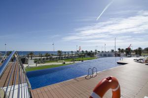 a swimming pool with a slide on a wooden deck at Ocean View by Mar Holidays in Arenales del Sol