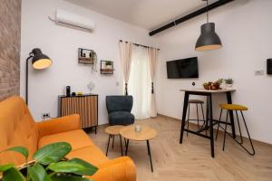 a living room with a couch and a table at Relaxing Holiday Apartment in Kornić