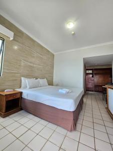a bedroom with a large bed in a room at Recife Mar Flats Hotel in Recife