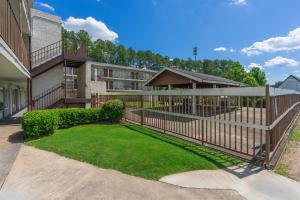 a fence in front of a building with a yard at Budgetel Inn and Suites in Atlanta