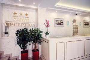 a lobby with a vanity and plants in a room at Voyage Hotel in Penza