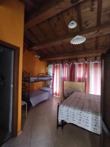 a bedroom with a bed and two bunk beds at La Cascina della Vachina in Poggio Bustone