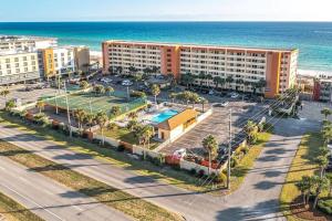 an aerial view of a resort with a tennis court and the ocean at Family Tides-The Ultimate Family Beachfront Condo! in Fort Walton Beach