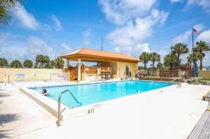 a swimming pool at a resort with a building at Family Tides-The Ultimate Family Beachfront Condo! in Fort Walton Beach