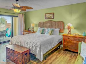 a bedroom with a bed and a table and a window at Family Tides-The Ultimate Family Beachfront Condo! in Fort Walton Beach +47 photos