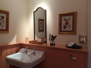 a bathroom with a sink and a mirror at Melfort House in Kilmelfort