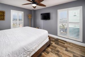 a bedroom with a bed and a ceiling fan at Gulfside 501 in Fort Walton Beach +40 photos