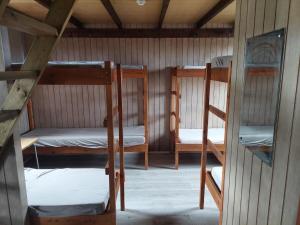 a room with three bunk beds in a cabin at Fremstaver in Blaskogabyggo